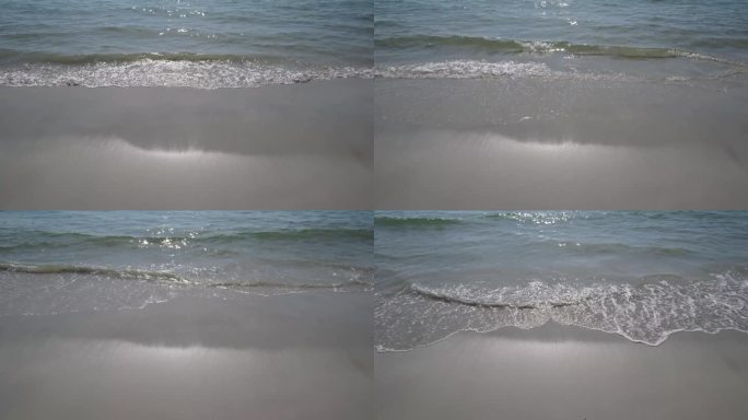 海水在岸边荡起涟漪，打在白色的沙滩上。