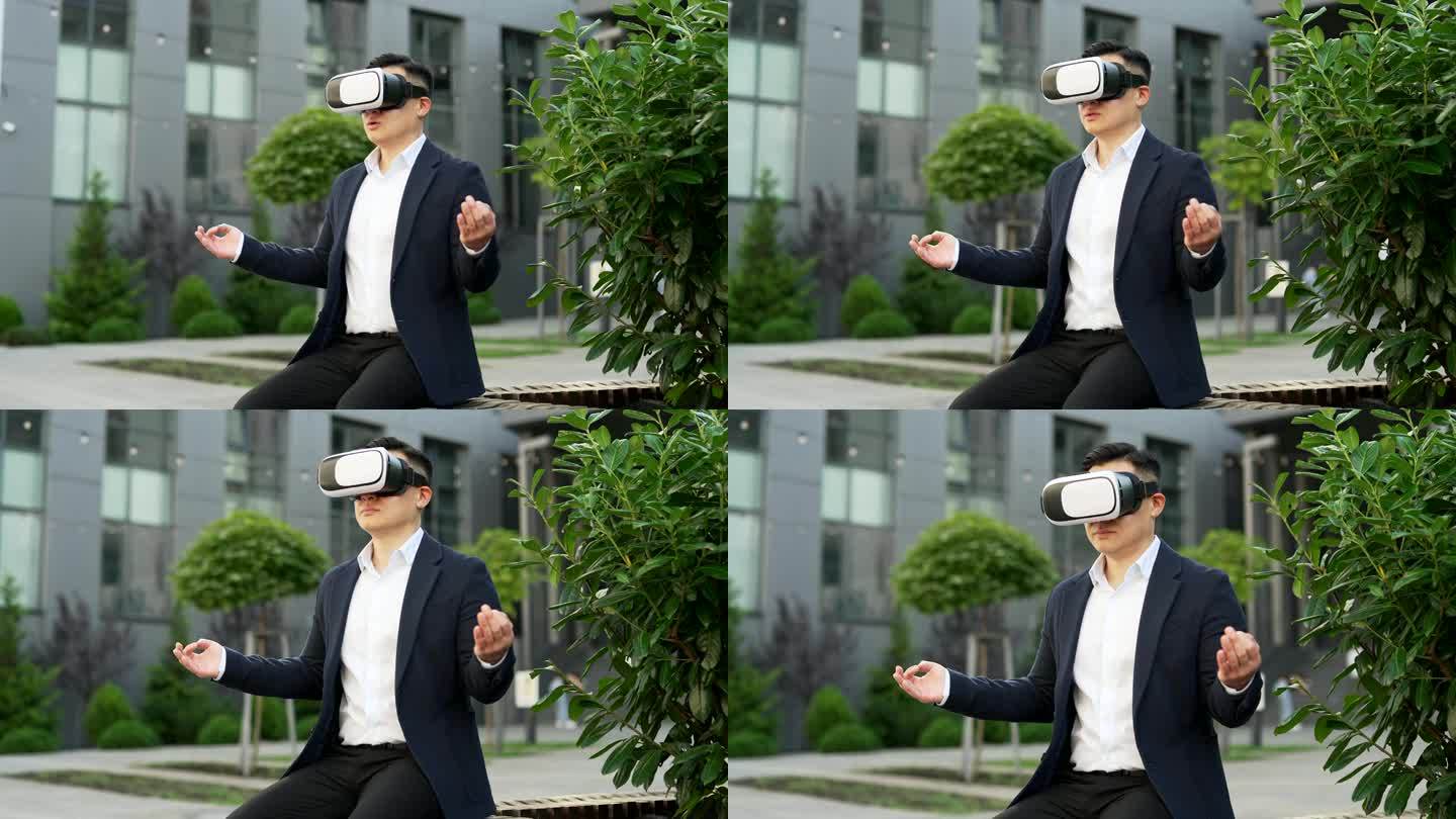 身着正装的亚洲商人坐在办公大楼附近街道的长椅上，戴着VR眼镜沉思