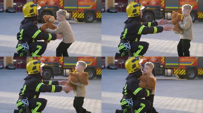 消防员给一个被救的孩子一个玩具并拥抱他