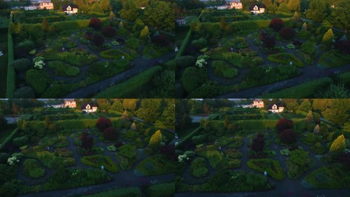 华丽的房子，有一个令人惊叹的大花园，早晨的阳光照在房子上。无人机拍摄。