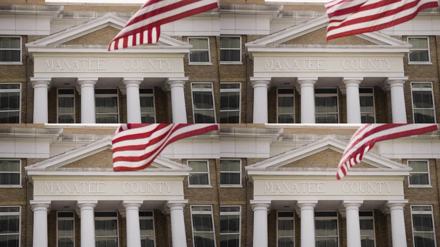 海牛县巡回法院书记员与美国国旗在慢动作飘扬