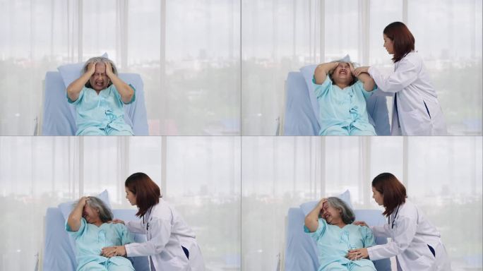 住院的一位老年女性患者痛苦地抱着头躺在病床上。