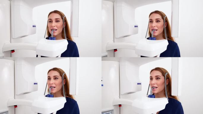 女性患者在x光机前摄下颌托面全景x线。一名妇女站在牙科x光机前进行牙科放射照相的激光精确投影。在现代