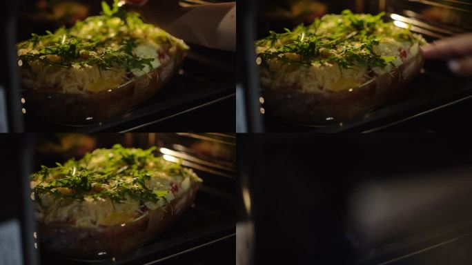 烤宽面条，用新鲜的芝麻菜叶装饰，放在一个玻璃烤盘里，放在烤箱里。一个女人关上了烤箱。特写镜头。