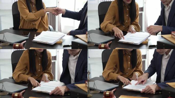 律师或法官与客户坐在一起签署重要合同并握手。司法机关和立法机关的法律概念一致。慢动作视频