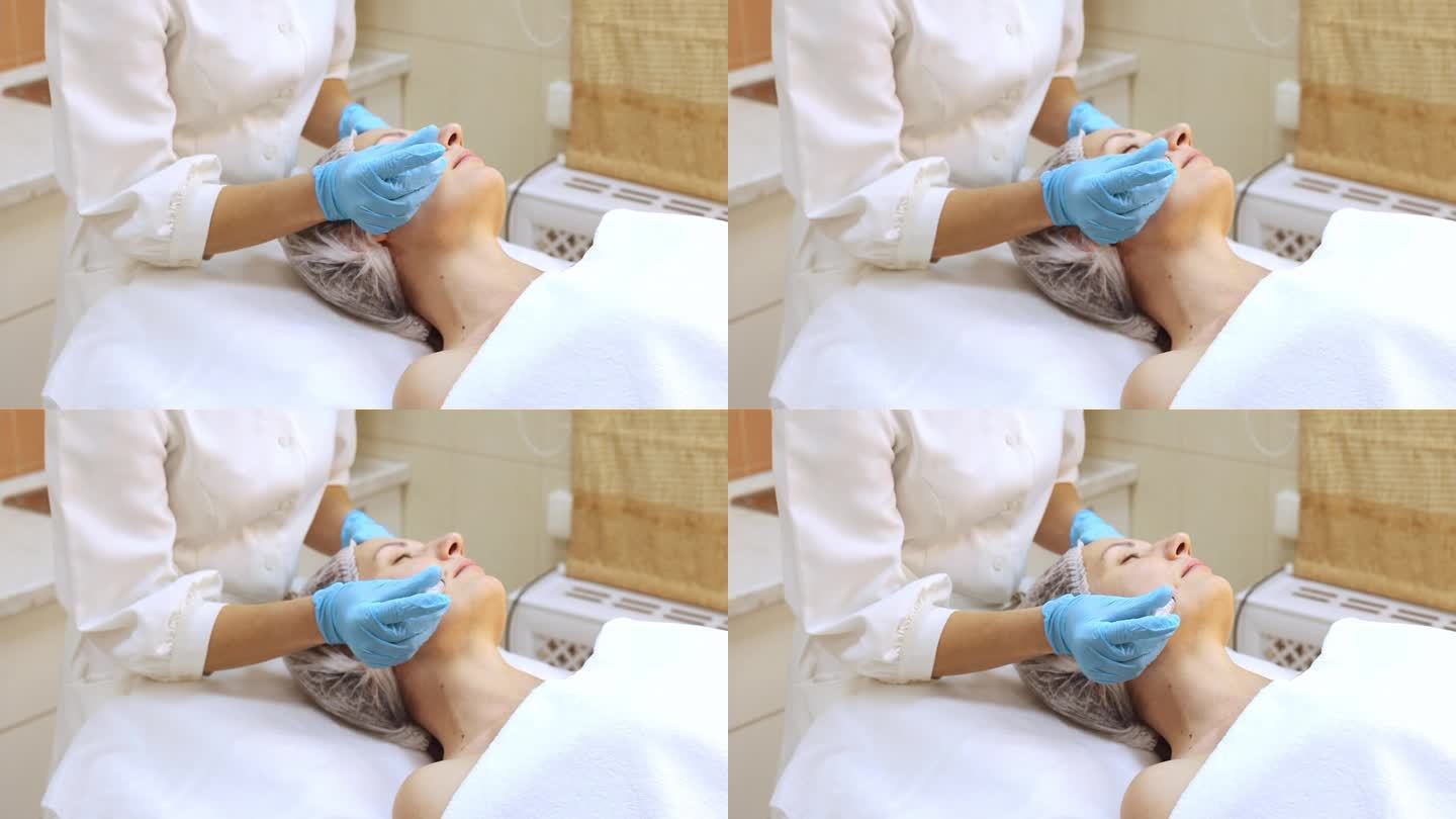 美容师正在给客户注射肉毒杆菌素，给客户做面部美容，手戴手套，特写镜头。