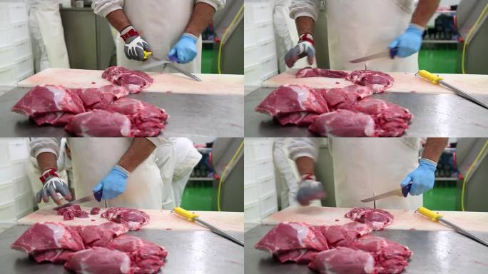 带着锁子甲网手套的肉类包装厂工人正在切生肉
