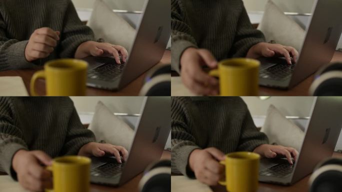人，手和喝咖啡与笔记本电脑远程工作，研究或在线通信在家里。自由职业者在家里用一杯茶、杯子或早晨的饮料
