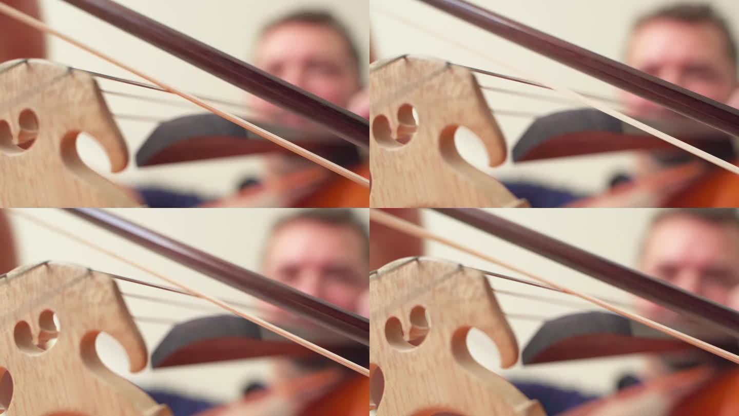 用大提琴弓演奏大提琴的近景。