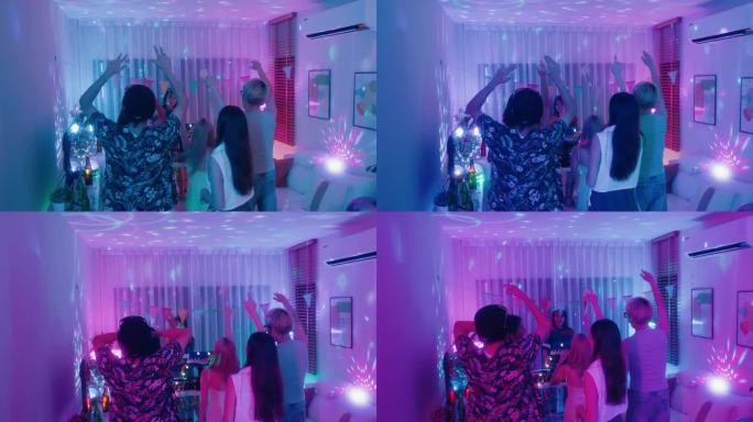 不同的一群朋友在晚上的色彩缤纷的家庭聚会上与EDM DJ一起有节奏地跳舞。多元文化的朋友在大学宿舍聚