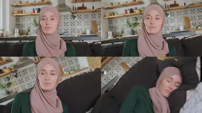 戴头巾的穆斯林妇女倒在沙发上，闭上眼睛，肖像。镜头移到一边。概念疲劳，疲惫，倦怠，作业，停止世界，睡
