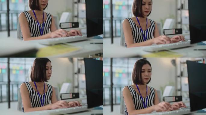 专注和专注的工作与亚洲女性专注于她的工作任务，在办公室专业，专注和富有成效的工作环境，使其成为一个理