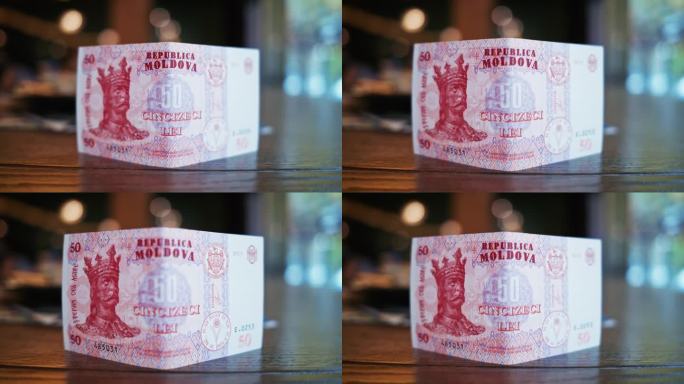 近距离观察桌子上摩尔多瓦共和国发行的50列伊红色钞票