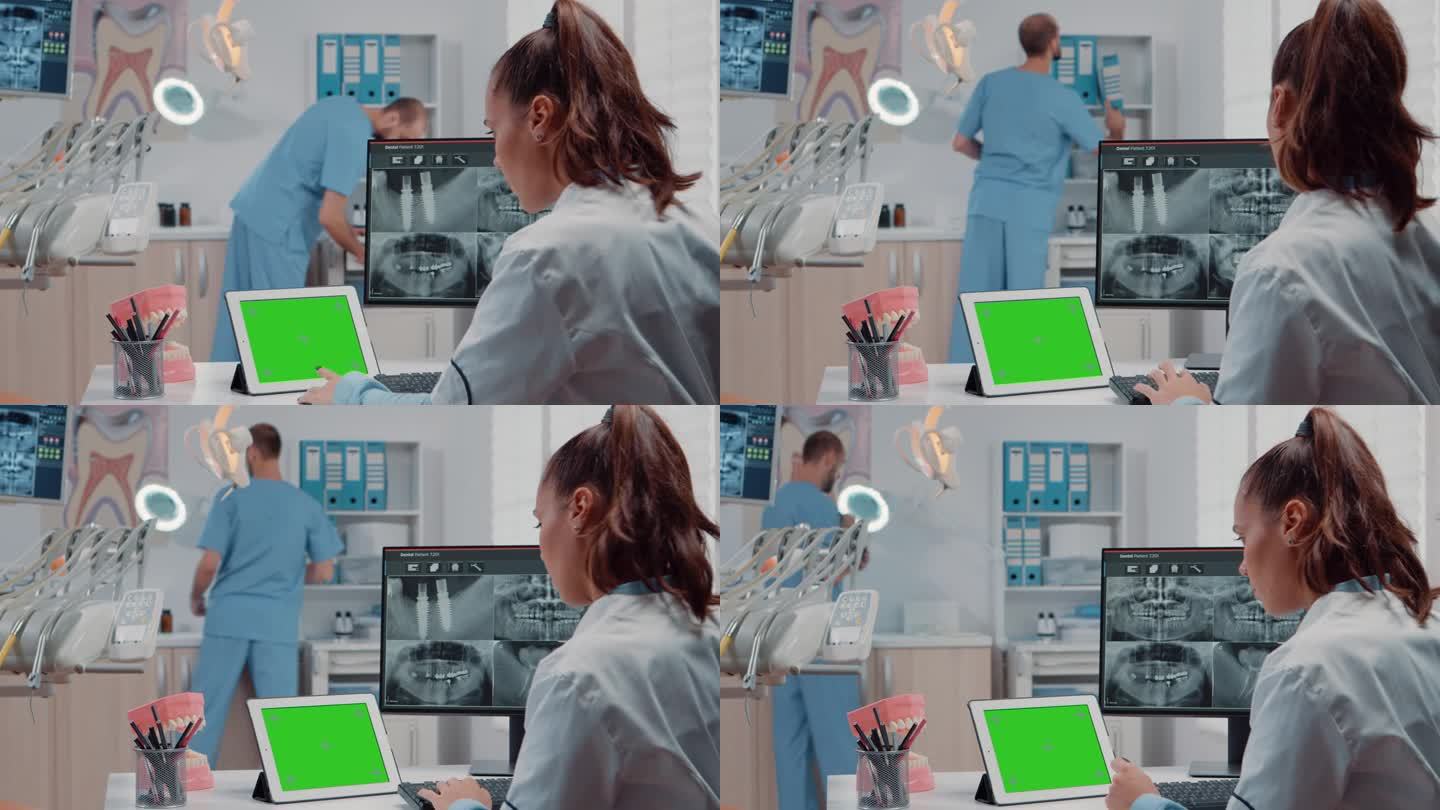 正畸医生在平板上使用水平绿色屏幕