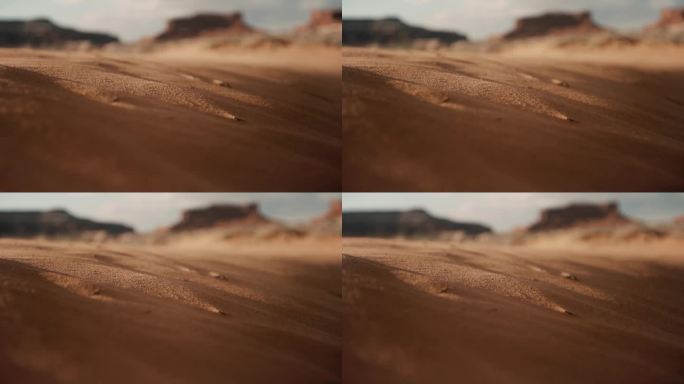 日落时沙漠风吹起的沙粒
