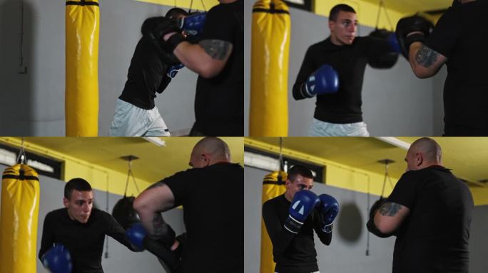 武术教练与年轻的拳击手对练，拿着拳击垫供拳手击打