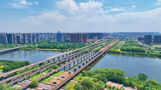 航拍中国高铁行驶在城市河流大桥上