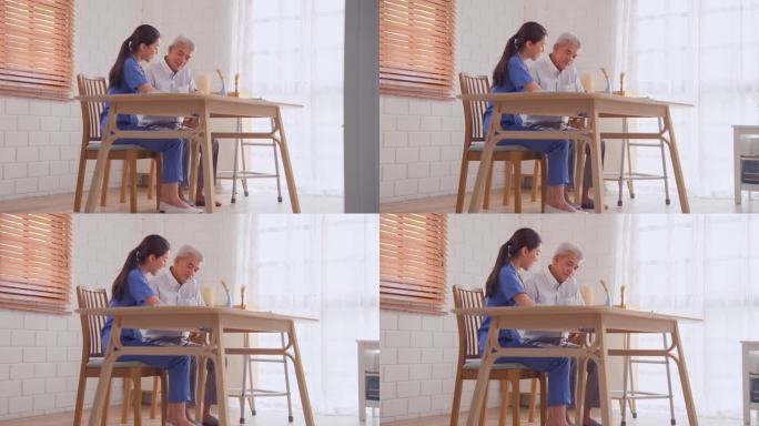 亚洲年轻护理护士在家检查老年男性病人。有吸引力的美丽的专家照顾妇女的支持，给予建议和咨询长辈成熟的祖