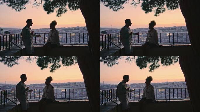 恋人的剪影在夕阳下聊天。打手势的人讲故事