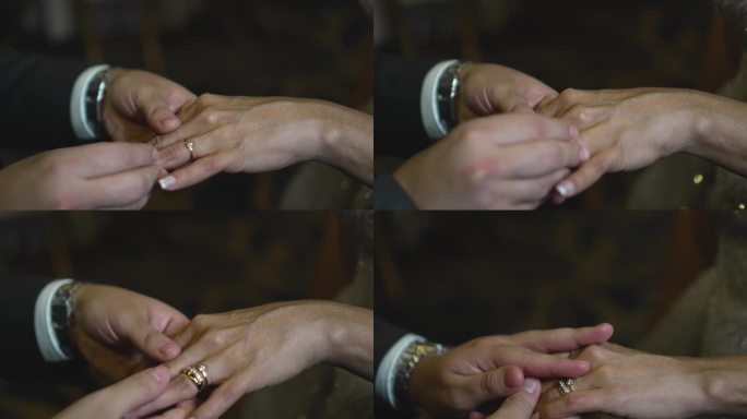 在婚礼上，新郎把戒指戴在新娘的手指上。婚礼的细节。