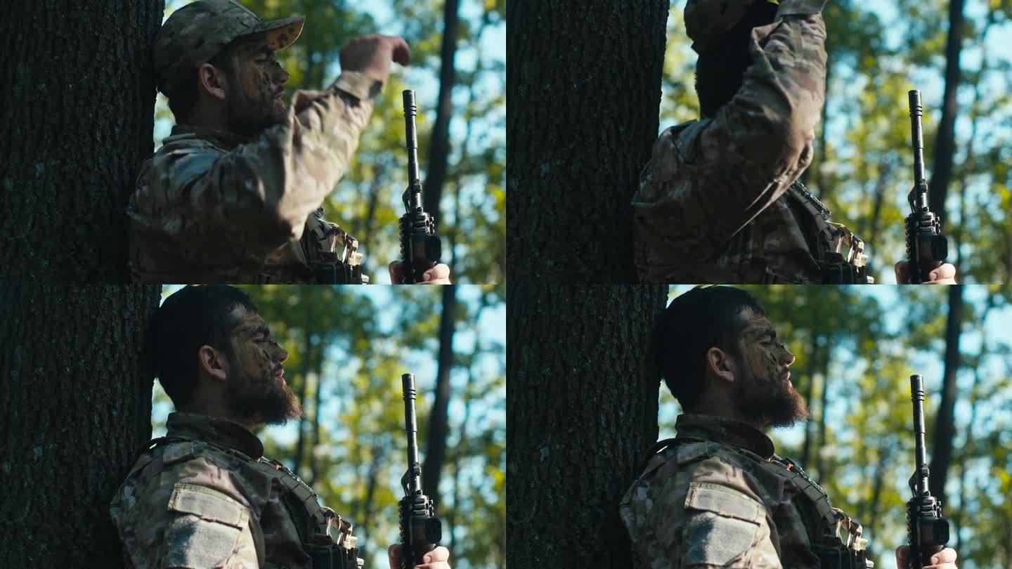 疲惫的士兵靠在森林里的一棵树上摘下帽子
