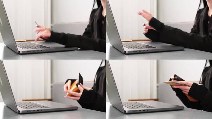 一名年轻女子手持银行卡，在房间的桌子上通过笔记本电脑进行网上购物的特写。网上购物和使用信用卡的概念。
