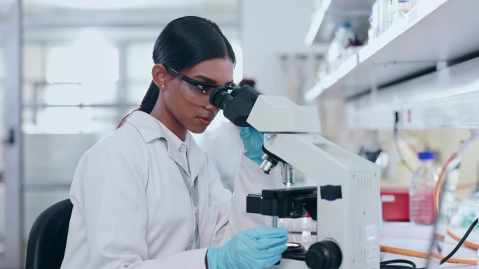 显微镜，科学和女性在实验室研究，分析和研究基因，粒子或dna。快乐的年轻科学家，生物技术和检查镜头审