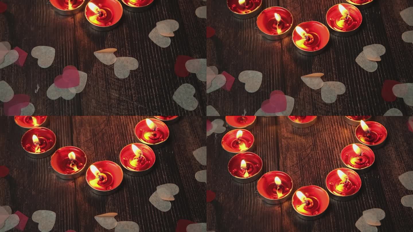 红色的蜡烛茶灯在木制背景。庆祝装饰圣诞，浪漫情人节。装饰和放松符号