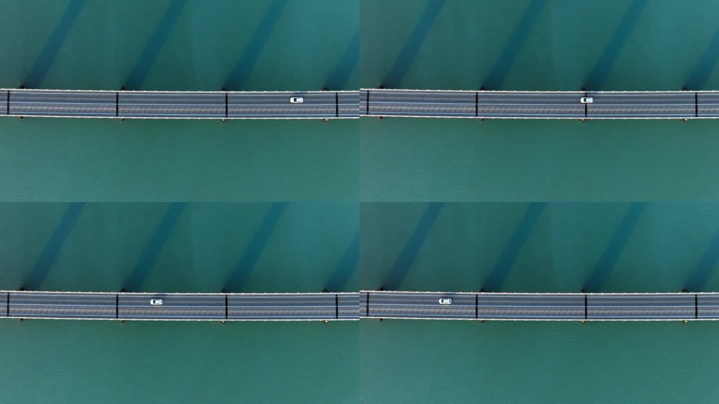 蓝绿色海水上的桥。美丽的城市基础设施。史诗公路汽车鸟瞰图。冰岛的对称抽象景观。