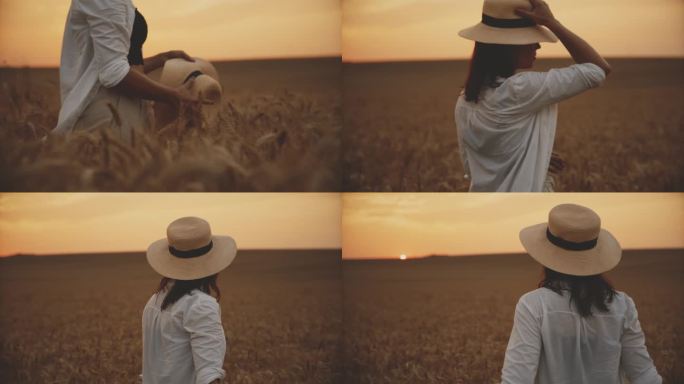 拿着帽子在麦田里欣赏日落美景的女人