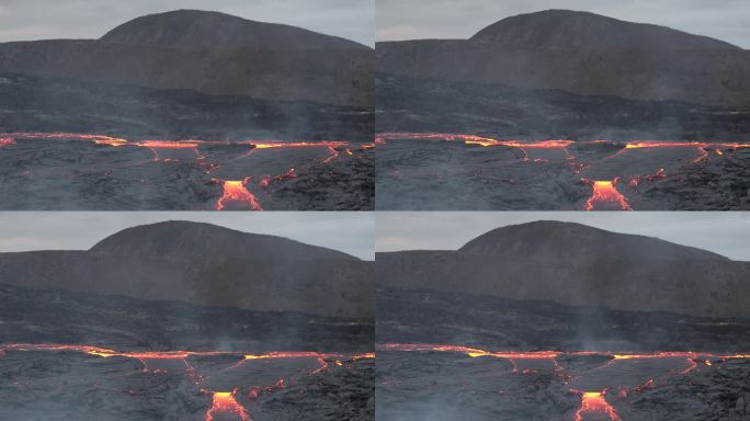 冰岛。火山喷发。炽热的熔岩正在蔓延。火山熔岩河的景观，从地球的地幔中喷出天然的热液体。全球变暖和气候