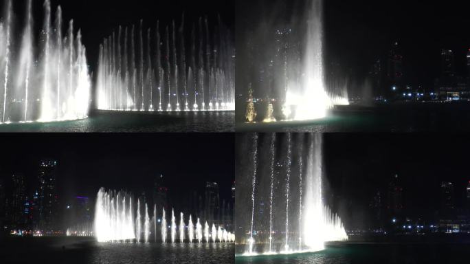 迪拜喷泉水上表演的美景在晚上跳舞喷泉。哈利法塔附近的迪拜购物中心里的镭射灯。