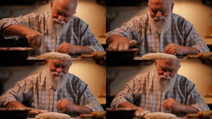 特写镜头。一位留着胡子的秃顶老人穿着衬衫，在木桌上撒上面粉，用手揉着一块长方形的面团。男人微笑着对着