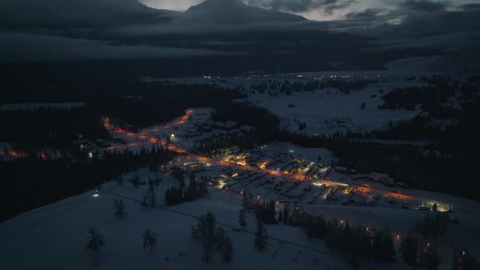 航拍冬季雪后新疆喀纳斯乡村夜景