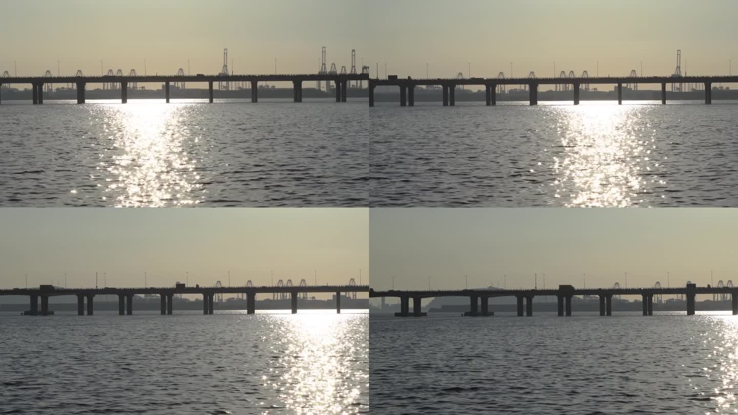 黄昏时横跨海洋的跨海大桥。平移镜头
