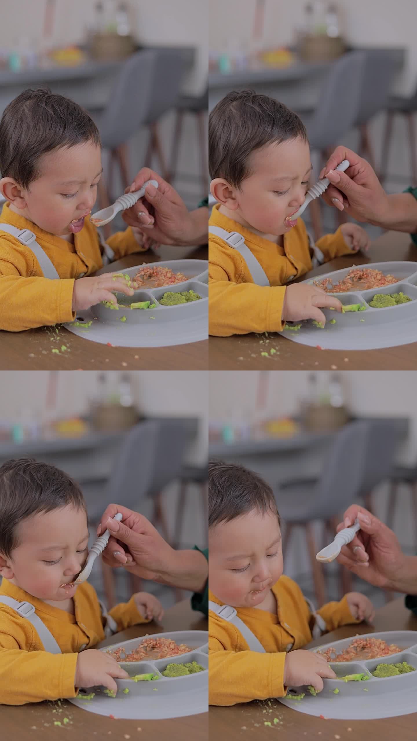 用勺子喂婴儿的脸部特写。婴儿辅食