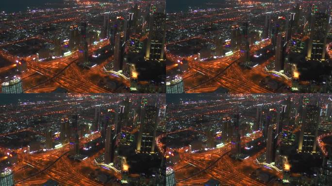 从哈利法塔拍摄的迪拜摩天大楼和繁忙的街道。傍晚现代城市的鸟瞰图。傍晚的城市灯光。