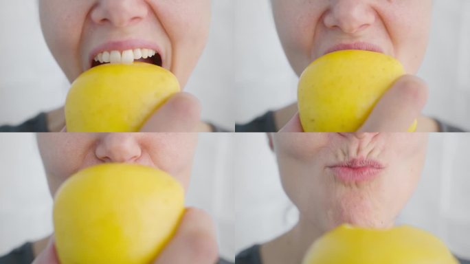 一个吃素的女人咬下一个熟透的黄苹果，这是特写。素食点心。