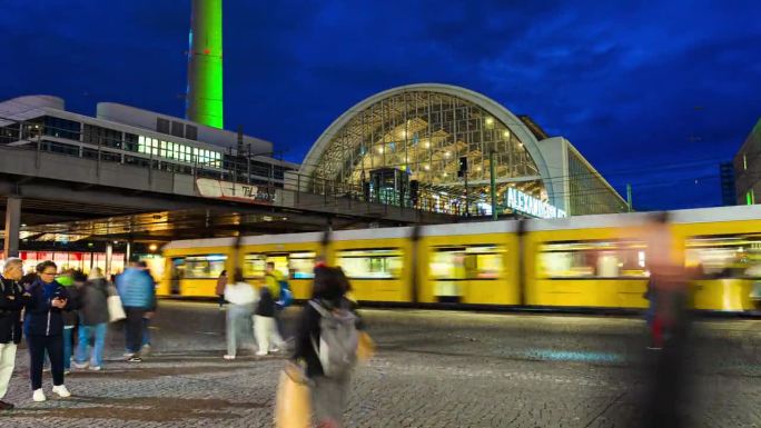 在德国柏林中部米特区的大型公共广场和交通枢纽亚历山大广场，游客在夜间步行和穿过道路和有轨电车站的时间