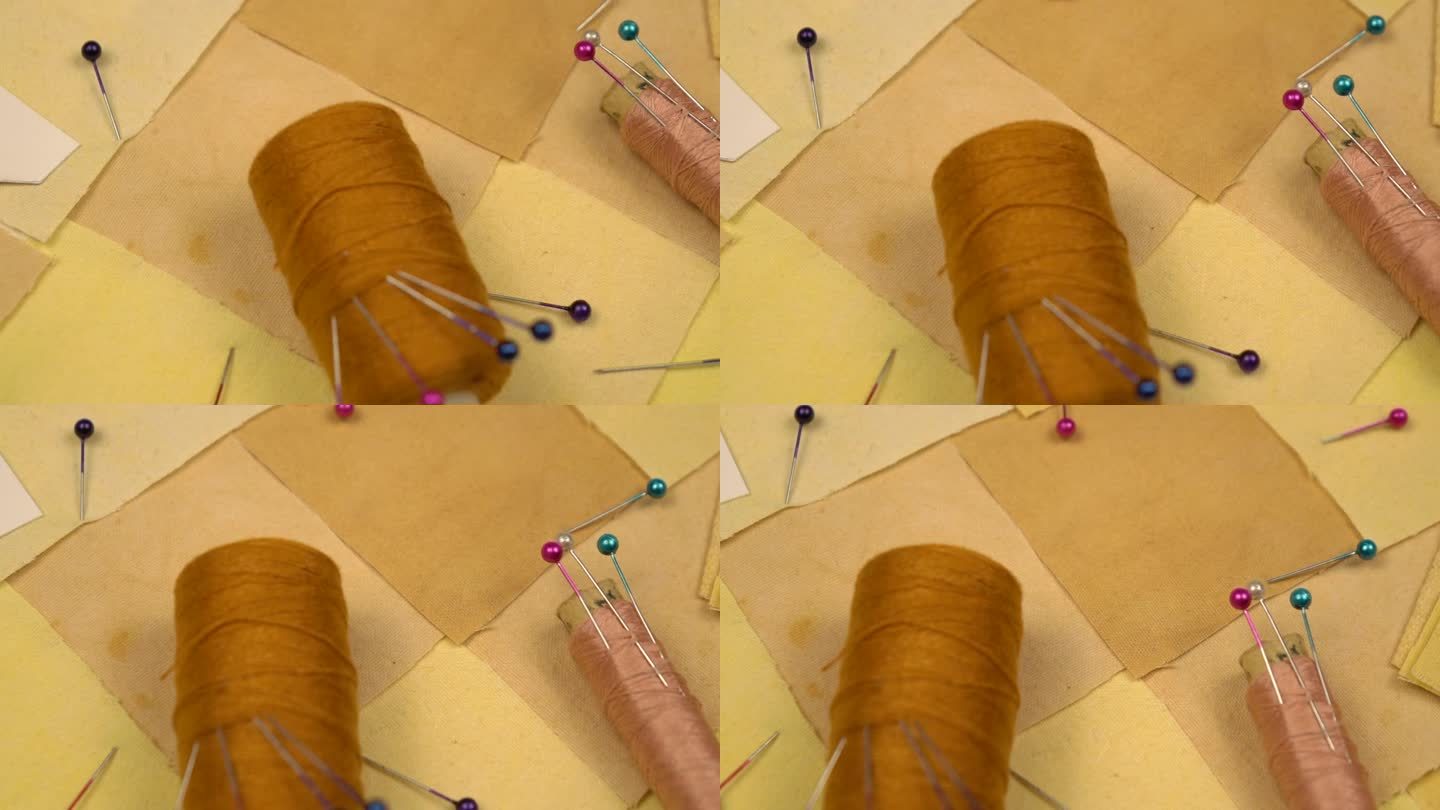 拼接缝纫的配件躺在拼接纺织品上，黄色调，慢动作