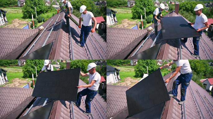 工人们在屋顶上建造太阳能电池板系统。安装人员携带光伏太阳能组件