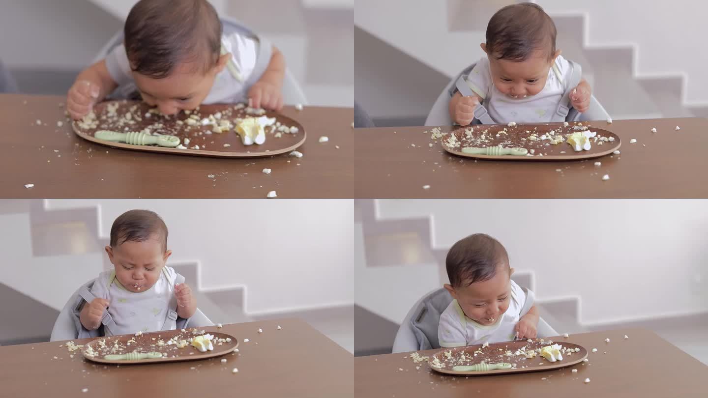 宝宝直接从餐桌旁的盘子里吃东西。婴儿主导的断奶概念。