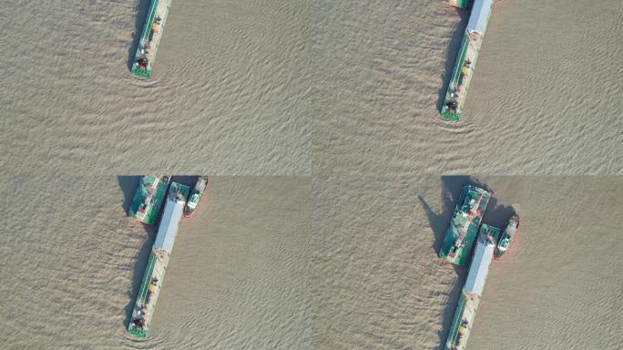 工业挖掘项目的高角度视图，在阳光明媚的日子里在河上工作的疏浚驳船，它的影子在水面上，无人机俯视图，4