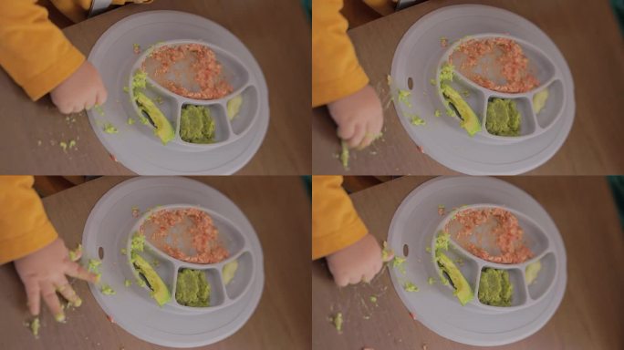 一个小孩拿着食物吃早餐的特写镜头