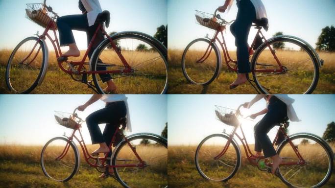 一名女子骑着自行车穿过阳光明媚的草地