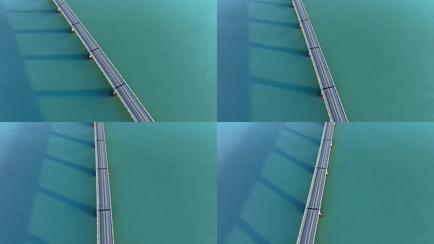 蓝绿色海水上的桥。美丽的城市基础设施。史诗公路汽车鸟瞰图。冰岛的对称抽象景观。