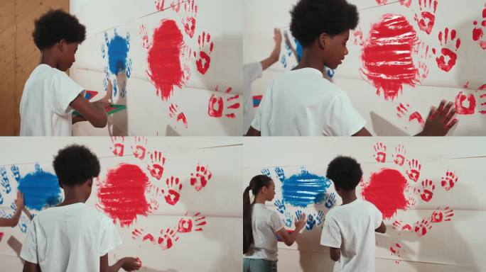 侧视图幼儿印章手与颜色和油漆墙。启迪