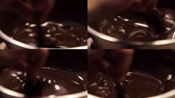 用木勺在锅中搅拌融化的液体黑巧克力