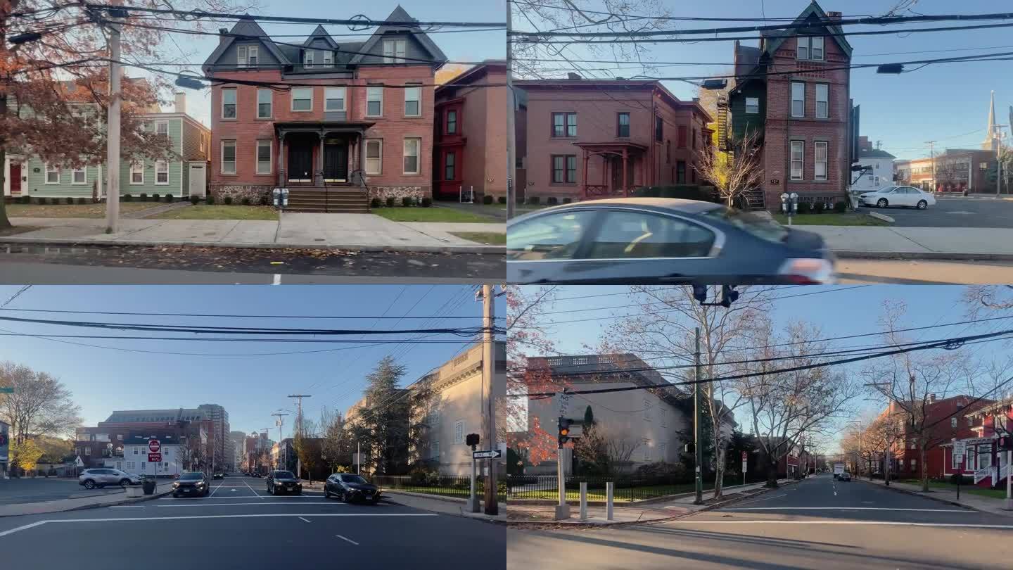 在一个晴朗、阳光明媚的日子里，康涅狄格州纽黑文的单户、多户和公寓式住宅的侧视图驾驶镜头