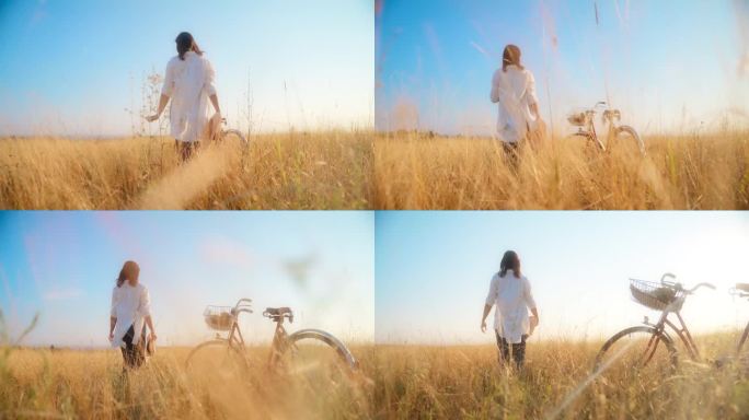 一名女子在草地上靠近停放的自行车行走